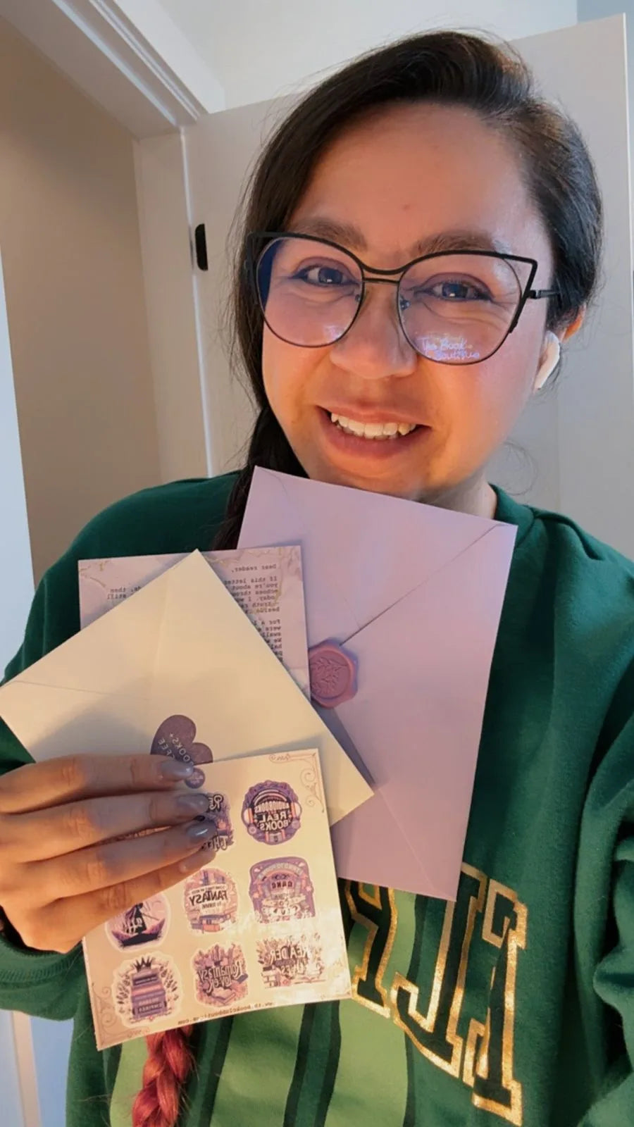 Galy holding a fan of Mail Club envelopes
