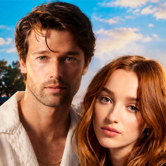 Promotional image of a dark-haired man in a white shirt and a red-haired woman against a bright, cloudy sky