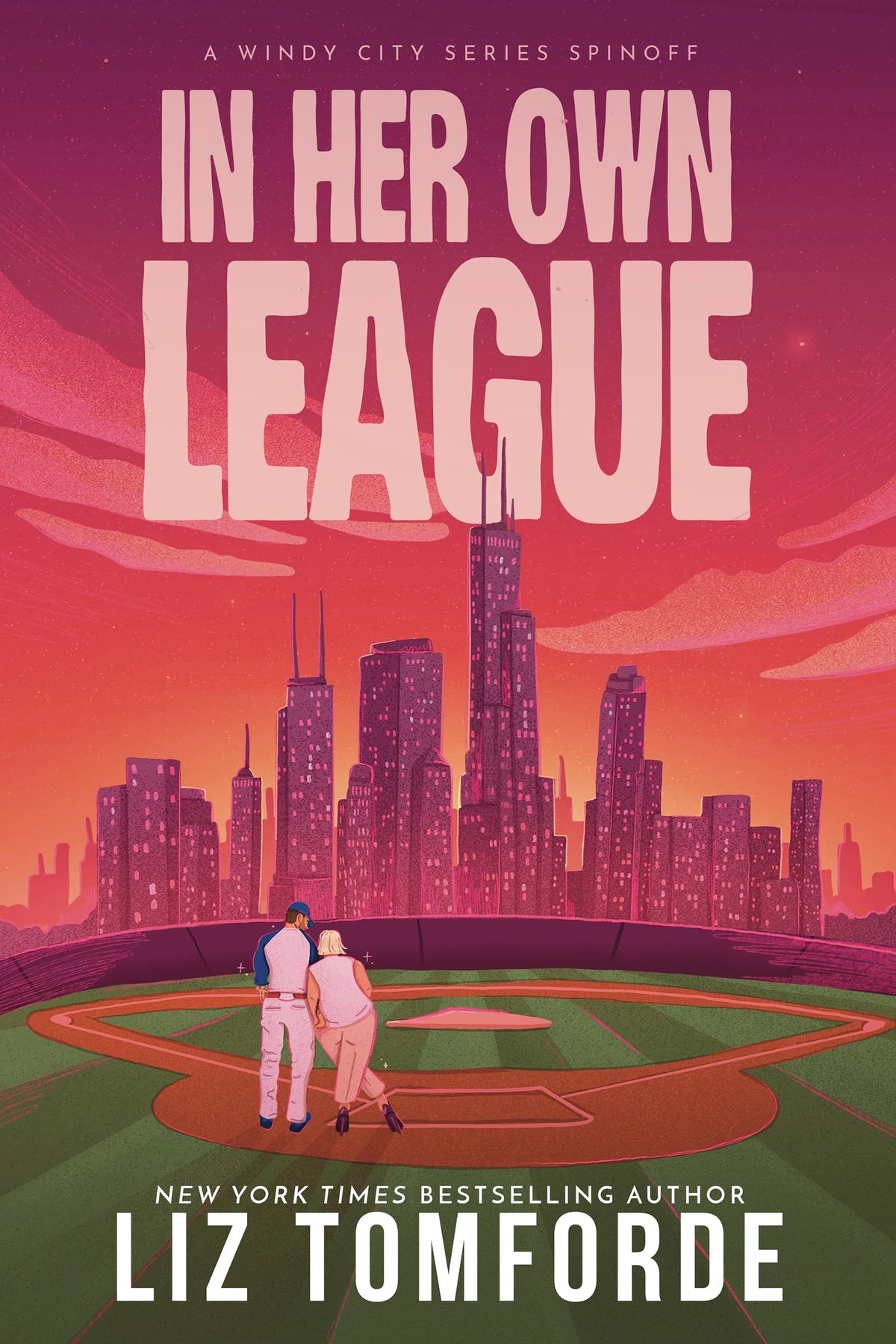 Cover of In Her Own League by Liz Tomforde: a couple on a baseball field against a pink Chicago skyline
